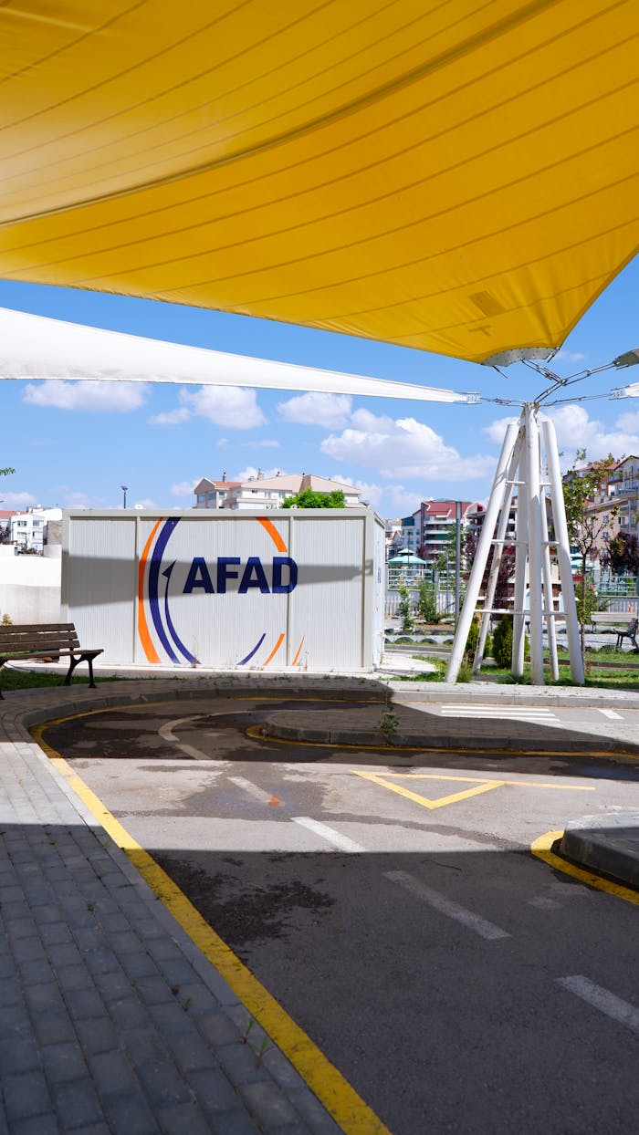 Yellow canopy over AFAD container at a public space in Ankara, Türkiye.